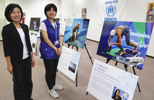 難民選手団の写真とＵＮＨＣＲ協会の青柳さん（左）と松岡陽子さん＝名古屋・栄の中日ビルで
