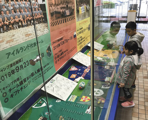 ３チームのユニホームなどが並ぶ展示ブース＝磐田市役所で