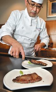 牛ロース肉のステーキを鉄板で焼く洋食料理長の清野さん＝大垣市の大垣フォーラムホテルで