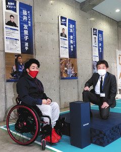 自身のタペストリーを見て「応援を力にしたい」と語る岩井孝義選手（左）＝魚津市ありそドームで