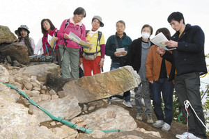 信長が築いたとみられる天守台の石垣に見入る見学者ら＝岐阜市の金華山で